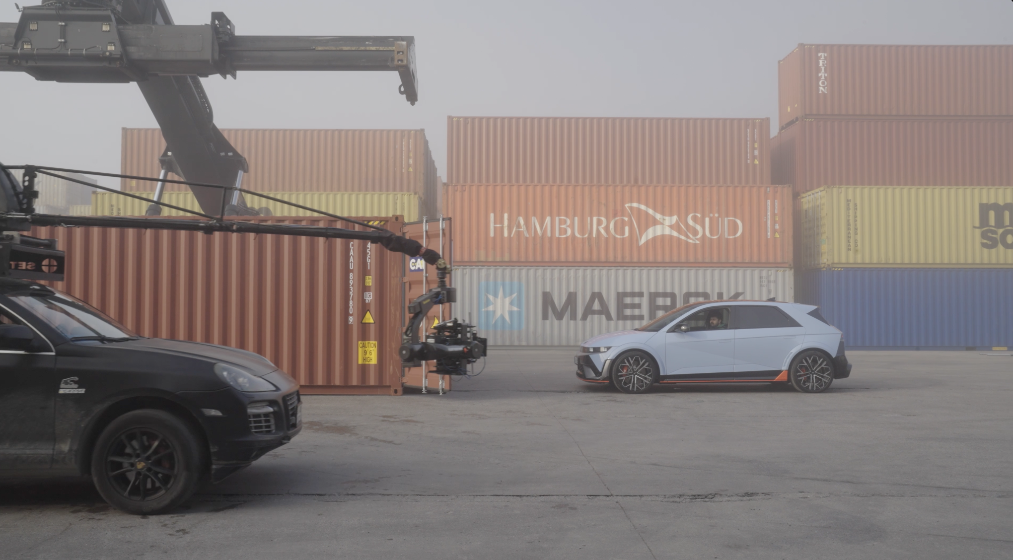 Camera vehicle filming a Hyundai Ioniq 5 N at a container terminal.